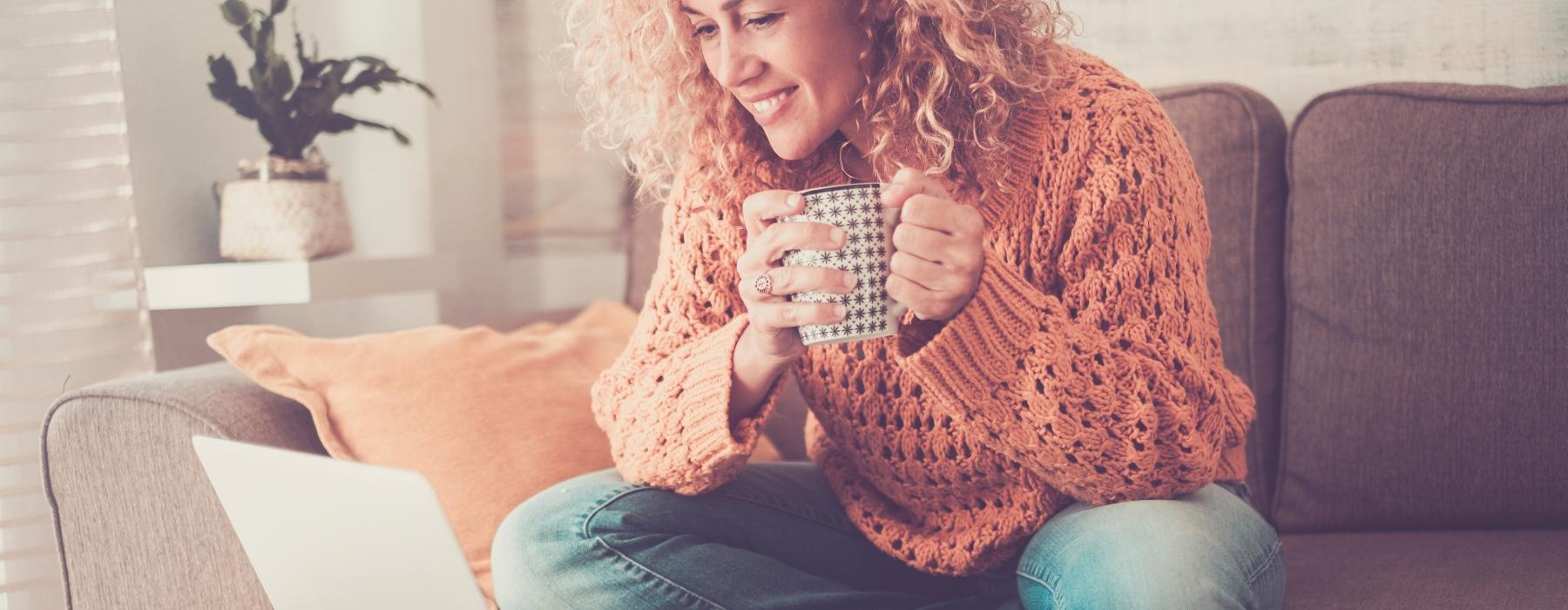 a person sitting on a couch and holding a can